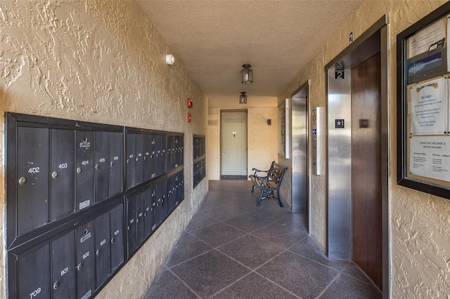 hallway featuring a mail area and elevator