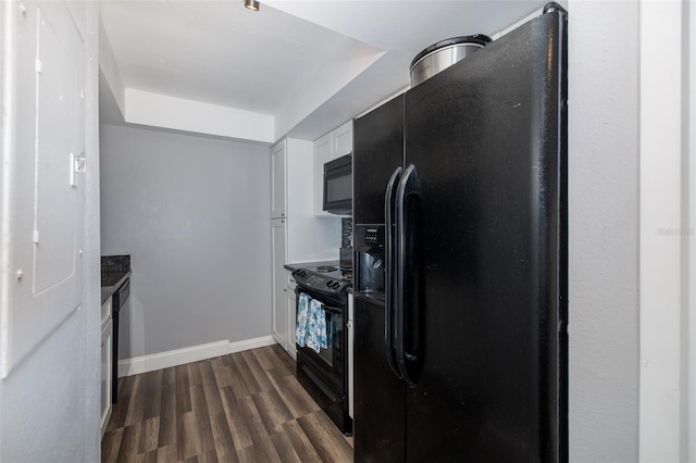 kitchen with dark wood-type flooring, black appliances, and white cabinets