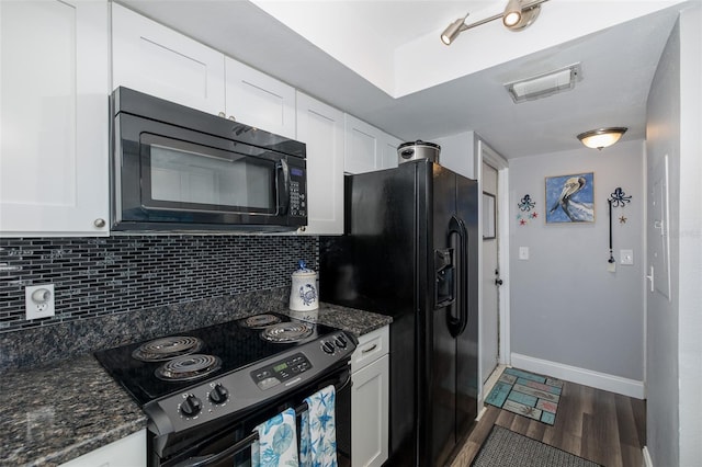 kitchen featuring dark wood-type flooring, tasteful backsplash, black appliances, dark stone counters, and white cabinets