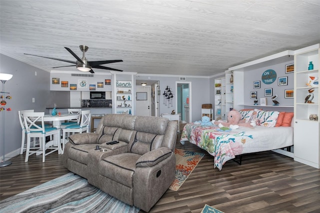 living room with crown molding, ceiling fan, and dark hardwood / wood-style flooring