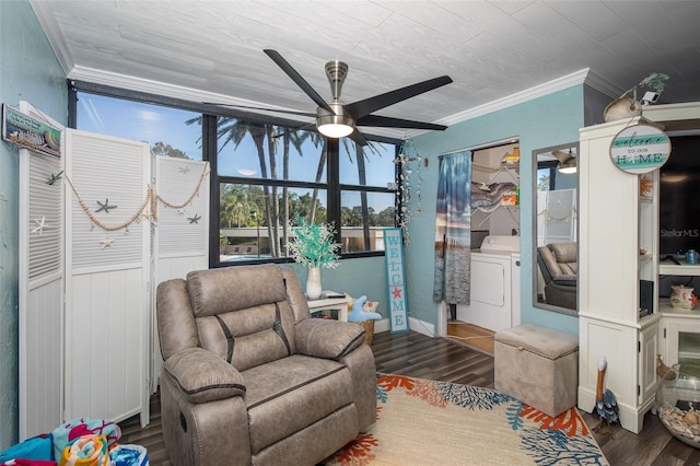 living area featuring dark hardwood / wood-style flooring, washer / dryer, ornamental molding, and ceiling fan