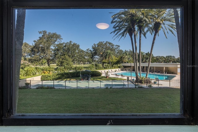 view of pool featuring a lawn