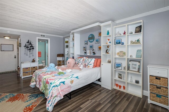 bedroom featuring ornamental molding, dark hardwood / wood-style floors, and connected bathroom