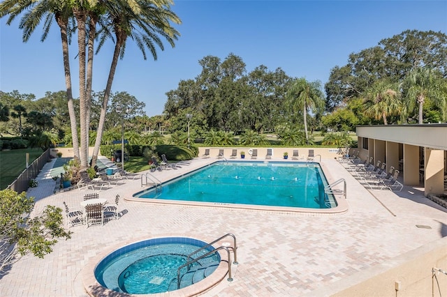 view of pool featuring a community hot tub and a patio area