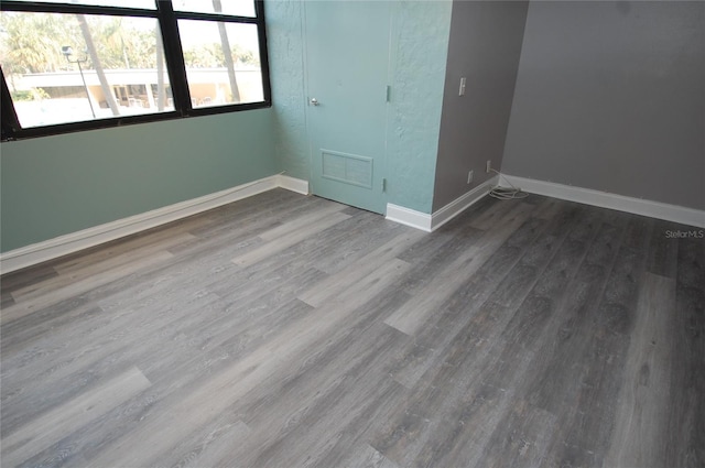 empty room with hardwood / wood-style flooring