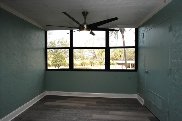 empty room featuring ceiling fan, ornamental molding, and dark hardwood / wood-style floors