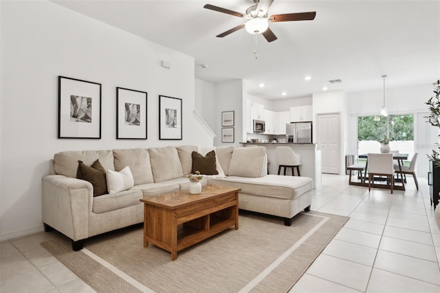 living room with ceiling fan and light tile patterned floors