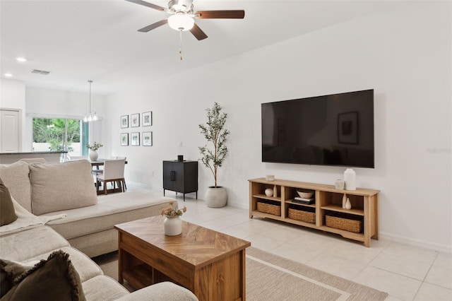 living room with ceiling fan and light tile patterned floors