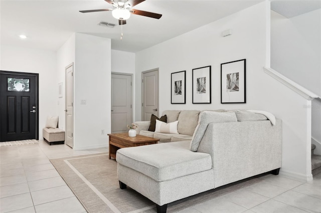 tiled living room with ceiling fan