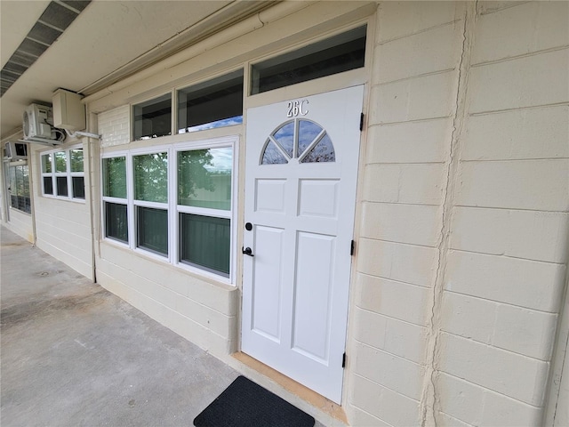 doorway to property with an AC wall unit