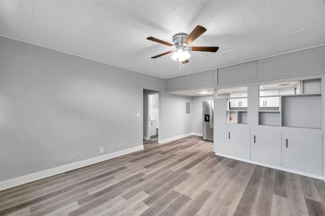 spare room with ceiling fan and light hardwood / wood-style flooring