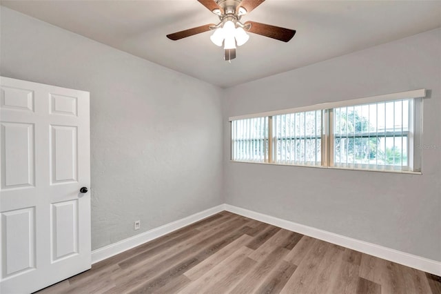 unfurnished room featuring hardwood / wood-style floors and ceiling fan