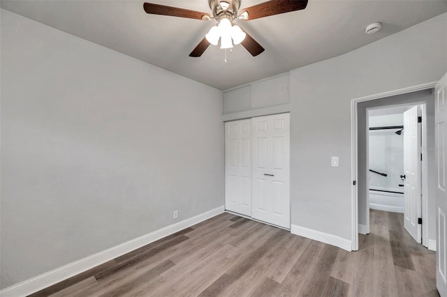 unfurnished bedroom featuring ceiling fan, light hardwood / wood-style floors, and a closet