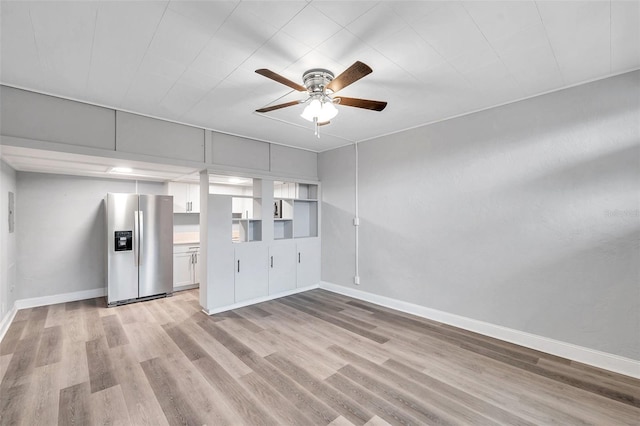 unfurnished living room featuring ceiling fan and light wood-type flooring