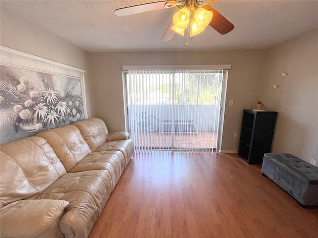 living room featuring hardwood / wood-style flooring and ceiling fan