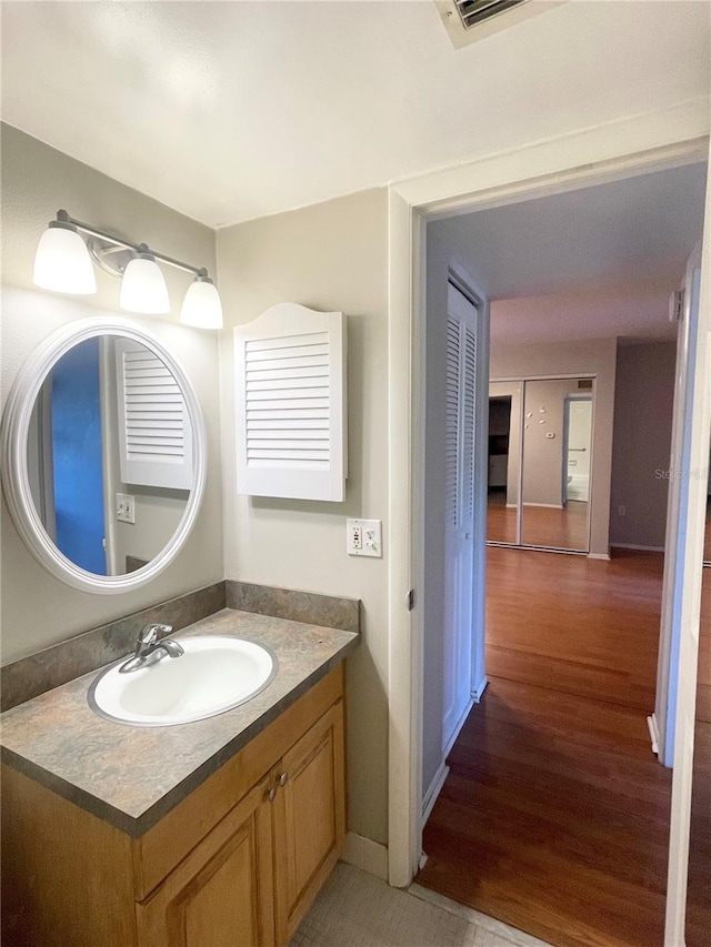 bathroom featuring vanity and hardwood / wood-style floors