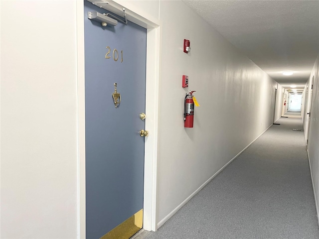 hallway featuring a textured ceiling