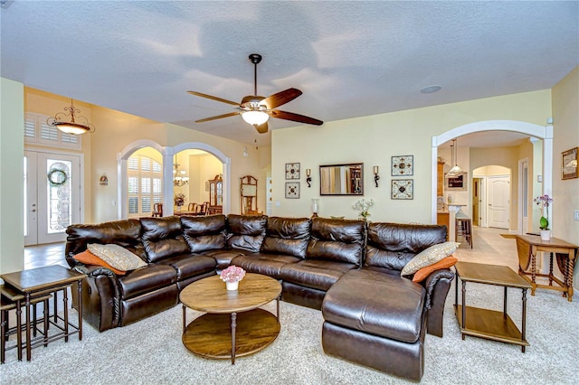 living room with light colored carpet and a textured ceiling