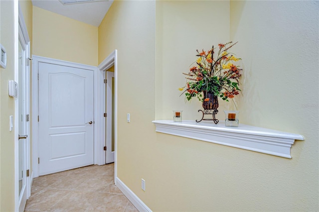 corridor featuring light tile patterned flooring