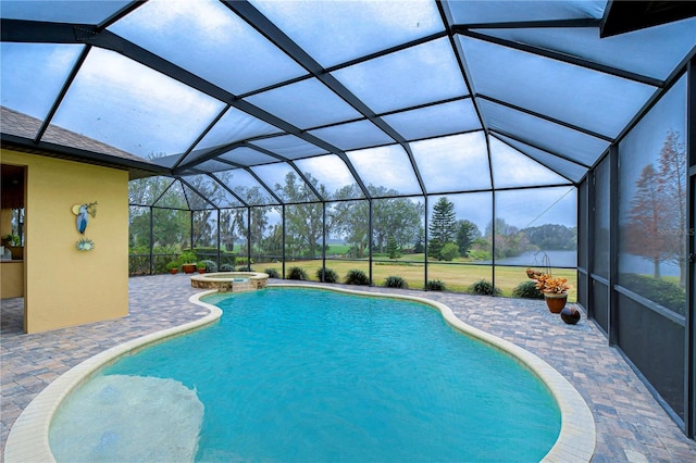 view of pool featuring an in ground hot tub, a patio, and glass enclosure