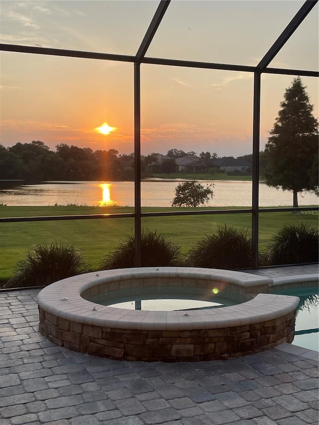 surrounding community featuring a water view, a yard, and a jacuzzi