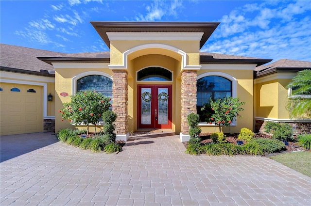 property entrance with a garage and french doors