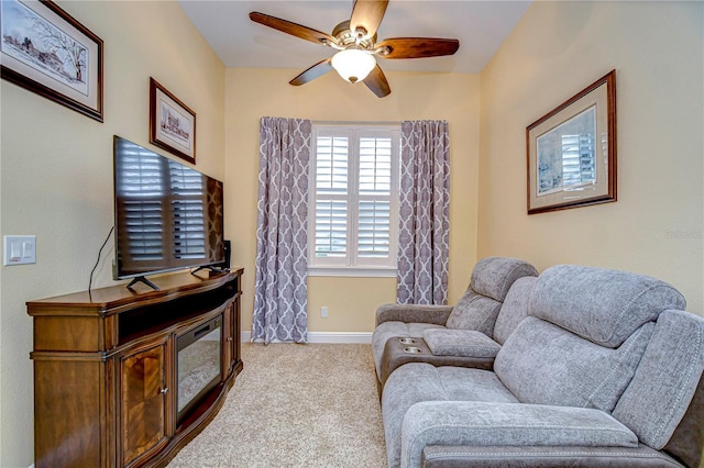 sitting room featuring light colored carpet and ceiling fan