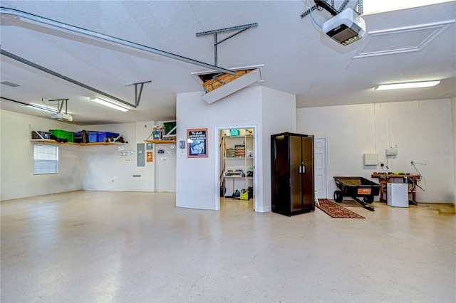 garage featuring a garage door opener and electric panel