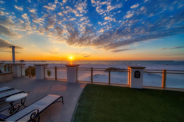 yard at dusk featuring a water view