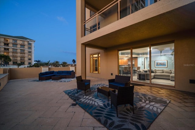 patio terrace at dusk with an outdoor living space