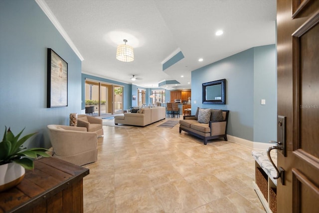 living room featuring a textured ceiling and ornamental molding