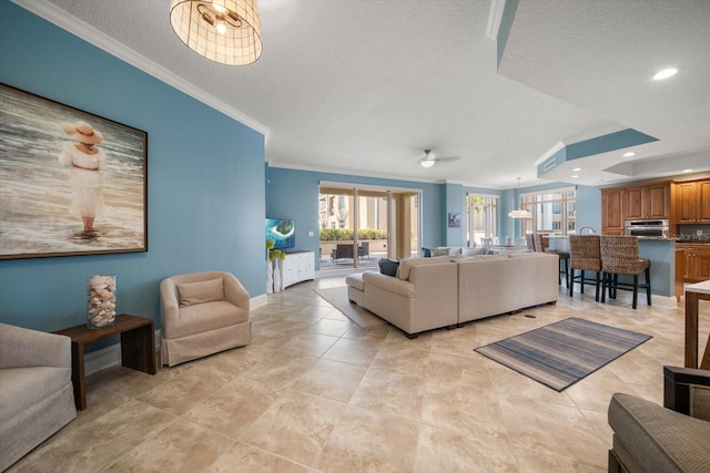 living room featuring ornamental molding and a textured ceiling