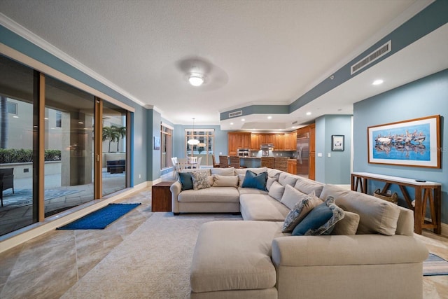 living room with crown molding and a textured ceiling