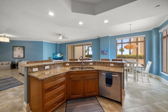 kitchen featuring decorative light fixtures, dishwasher, sink, a textured ceiling, and light stone counters