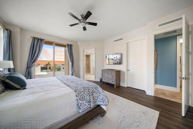 bedroom with a textured ceiling, connected bathroom, dark hardwood / wood-style flooring, access to outside, and ceiling fan