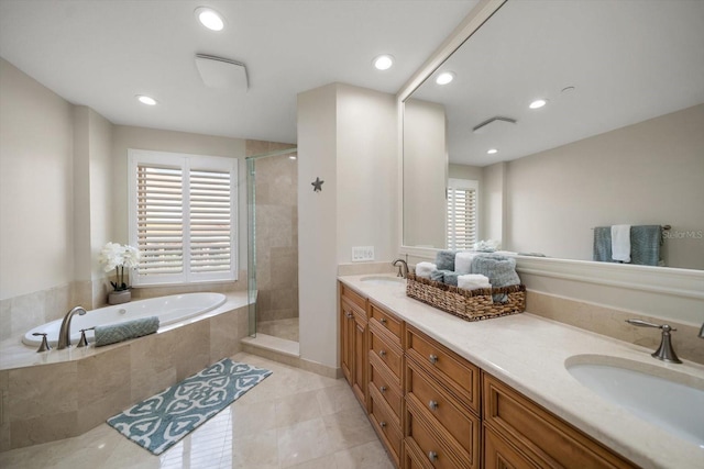 bathroom featuring vanity, independent shower and bath, tile patterned floors, and a wealth of natural light