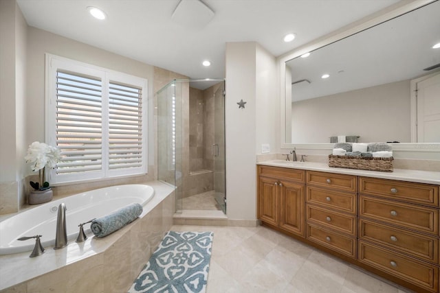 bathroom featuring shower with separate bathtub and vanity