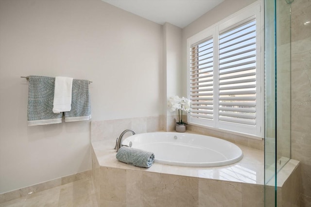 bathroom featuring tiled bath