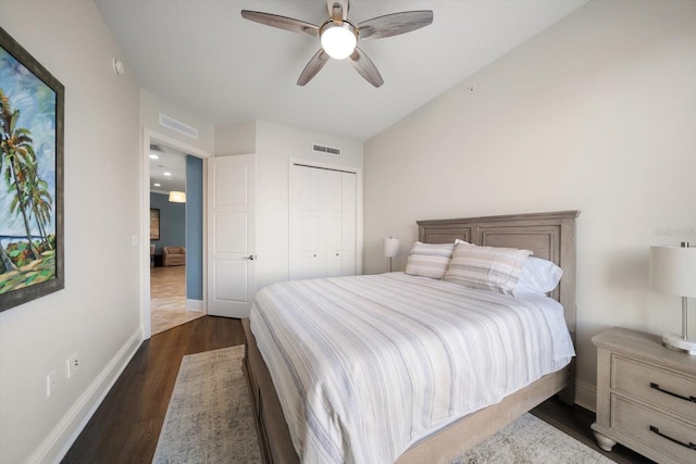 bedroom featuring dark wood-type flooring, a closet, and ceiling fan