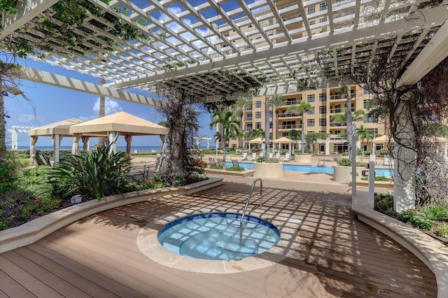 view of pool with a patio and a community hot tub