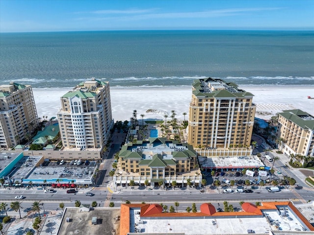 drone / aerial view featuring a water view and a view of the beach