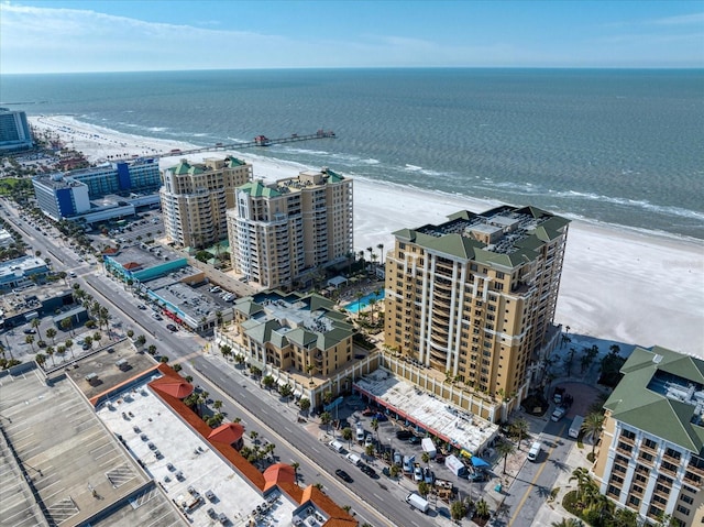 birds eye view of property with a water view and a view of the beach