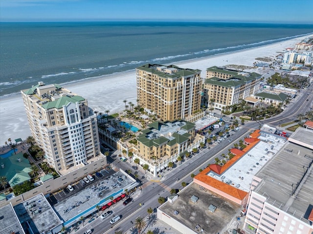 birds eye view of property with a beach view and a water view