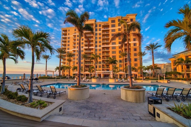 pool at dusk with a patio