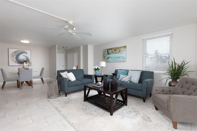 tiled living room with ceiling fan