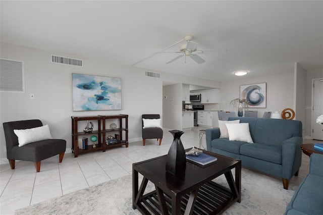 living room featuring ceiling fan and light tile patterned floors