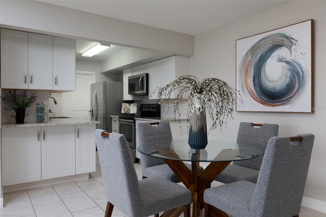 tiled dining area featuring sink