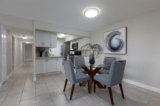 tiled dining room with sink