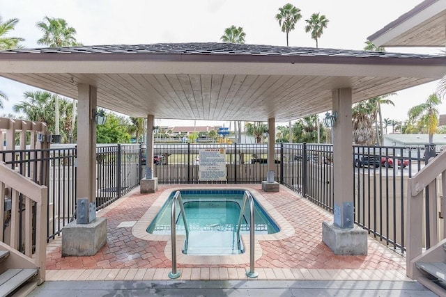 view of swimming pool featuring a community hot tub