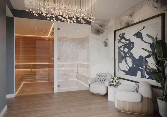 sitting room with an inviting chandelier and hardwood / wood-style floors